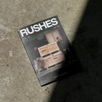 Book titled 'Rushes' on a concrete surface
